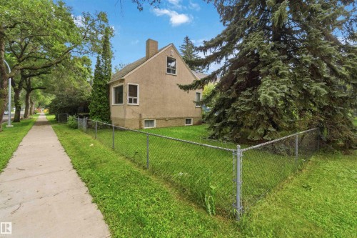 Stucco-sided home with a prominent chimney and multiple windows - 12243 104 Street Nw, Edmonton, AB - Outdoor