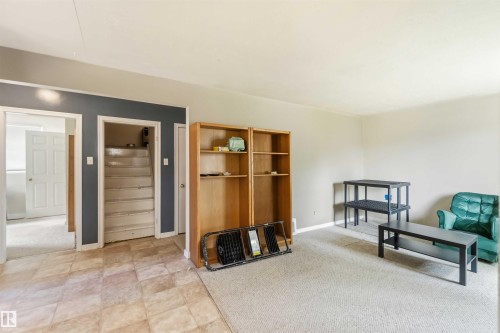 Spacious room featuring a combination of tiled and carpeted flooring - 12243 104 Street Nw, Edmonton, AB - Indoor Photo Showing Other Room