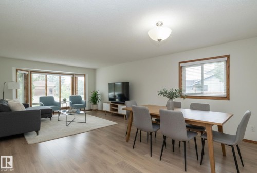 Wood-finish flooring throughout, bright bay windows, recessed lighting, and a neutral color palette - 11138 30 Avenue Nw, Edmonton, AB - Indoor