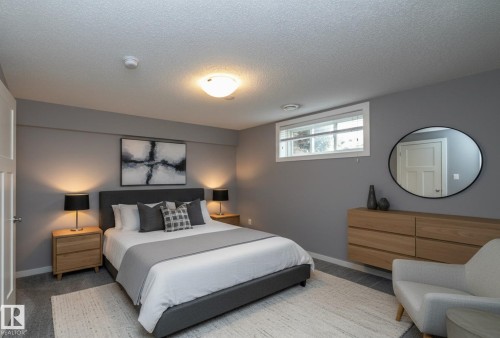 Gray painted walls with white trim, a fixed window, and a ceiling-mounted light fixture - 11138 30 Avenue Nw, Edmonton, AB - Indoor Photo Showing Bedroom