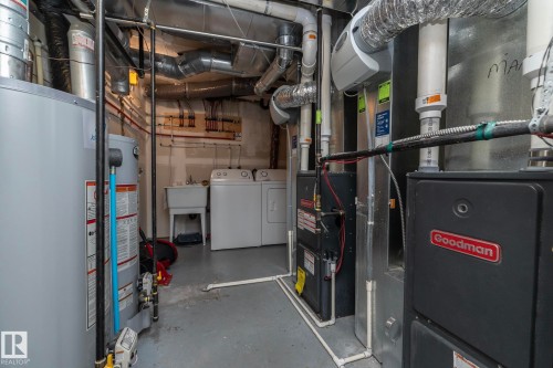 Laundry area featuring a utility sink, water heater, and a Goodman furnace - 11138 30 Avenue Nw, Edmonton, AB - Indoor Photo Showing Basement