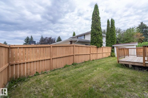 Private backyard featuring a wooden privacy fence, a raised wooden deck, and a detached storage shed - 11138 30 Avenue Nw, Edmonton, AB - Outdoor