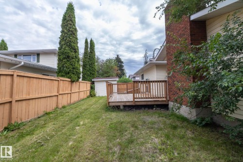 Wood deck with railing, wood privacy fence, brick chimney, exterior siding, and a storage shed - 11138 30 Avenue Nw, Edmonton, AB - Outdoor With Deck Patio Veranda