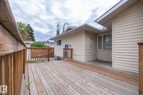 Expansive wood-finish deck with railing, featuring a lower deck section and a privacy fence - 11138 30 Avenue Nw, Edmonton, AB - Outdoor With Deck Patio Veranda With Exterior