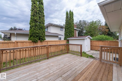 Spacious composite deck featuring multiple levels with horizontal wood-finish railings, built-in bench seating, and access to the fenced backyard - 11138 30 Avenue Nw, Edmonton, AB - Outdoor With Deck Patio Veranda With Exterior