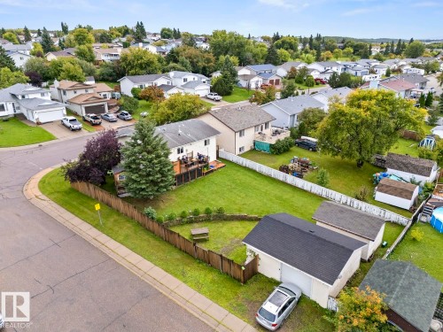 Expansive corner lot with mature trees, fenced backyard, and a raised wooden deck - 5330 43 Street, Cold Lake, AB - Outdoor With View
