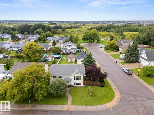 Single-story residence featuring a front lawn and paved driveway - 5330 43 Street, Cold Lake, AB - Outdoor With View