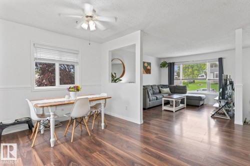 Open concept living space with wood-finish flooring, white walls, and a ceiling fan - 5330 43 Street, Cold Lake, AB - Indoor