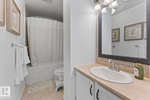 Cultured marble vanity with integrated sink, chrome faucet, and mosaic tile backsplash - 5330 43 Street, Cold Lake, AB - Indoor Photo Showing Bathroom