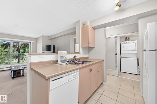 Kitchen featuring a built-in dishwasher, a single basin sink, and ample cabinet storage - #216 17003 67 Av Nw, Edmonton, AB - Indoor Photo Showing Kitchen With Double Sink