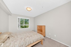 Recessed ceiling light, flush-mount ceiling light fixture, large window, light-colored walls, carpeted flooring - 