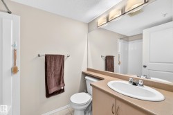 White vanity with an integrated sink and chrome faucet, full-width mirror, and overhead four-light fixture - 
