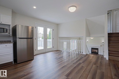 1028 James Crescent Nw, Edmonton, AB - Indoor Photo Showing Other Room With Fireplace