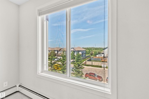 White window frame with a multi-pane design - #318 5521 7 Av Sw Sw, Edmonton, AB - Indoor Photo Showing Other Room