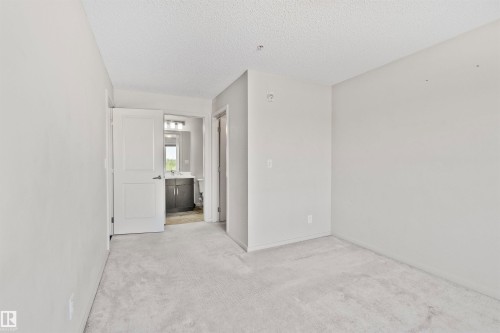 Neutral wall finishes and light-toned carpeting - #318 5521 7 Av Sw Sw, Edmonton, AB - Indoor Photo Showing Other Room