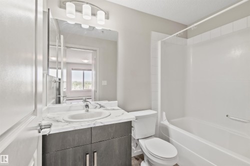 Vanity with a polished chrome faucet and a white oval sink - #318 5521 7 Av Sw Sw, Edmonton, AB - Indoor Photo Showing Bathroom