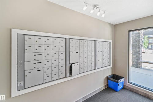 Wall-mounted community mailboxes - #318 5521 7 Av Sw Sw, Edmonton, AB - Indoor Photo Showing Other Room