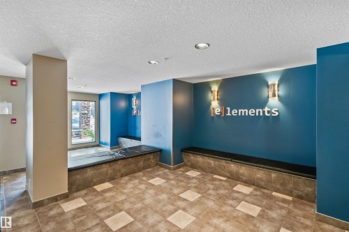Tiled flooring with a geometric pattern, built-in benches, recessed lighting, and wall-mounted sconces - #318 5521 7 Av Sw Sw, Edmonton, AB - Indoor Photo Showing Other Room