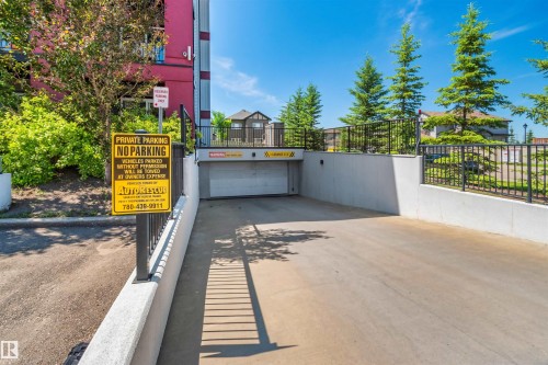 Concrete driveway leading to an underground parking garage - #318 5521 7 Av Sw Sw, Edmonton, AB - Outdoor