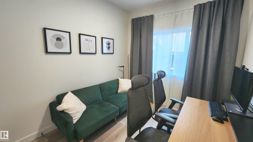 Neutral wall finishes, window with dual curtain treatments, and wood-finish flooring - 220 28 Street Sw, Edmonton, AB - Indoor