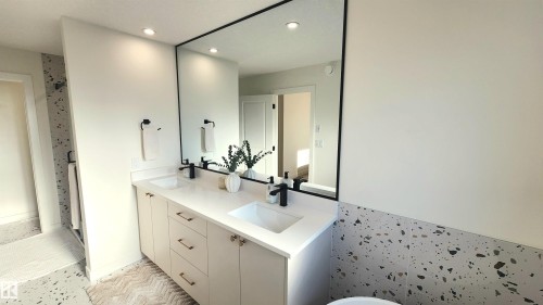 Double vanity with undermount sinks, matte black fixtures, and gold-finish hardware - 220 28 Street Sw, Edmonton, AB - Indoor Photo Showing Bathroom