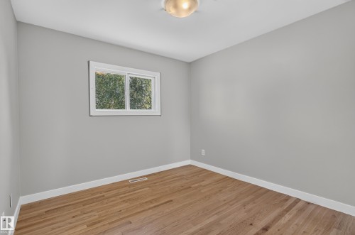 Hardwood-finish flooring, light gray wall paint, and white trim - 13214 123 Street Nw, Edmonton, AB 