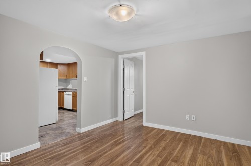 Wood-finish flooring throughout, light gray wall finishes, and white trim - 13214 123 Street Nw, Edmonton, AB 