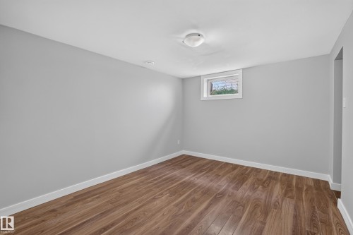 Wood-finish flooring, recessed lighting, and a white-framed window - 13214 123 Street Nw, Edmonton, AB 