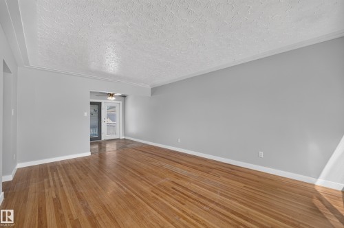 Hardwood flooring, painted walls, crown molding, ceiling fan, and French doors - 13214 123 Street Nw, Edmonton, AB 
