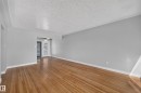 Hardwood flooring, painted walls, crown molding, ceiling fan, and French doors - 13214 123 Street Nw, Edmonton, AB 