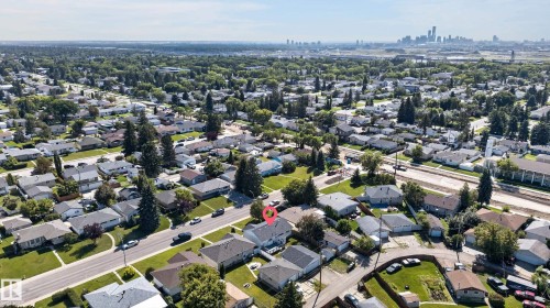 Aerial perspective showcasing a residential neighborhood with a distant cityscape - 13214 123 Street Nw, Edmonton, AB 