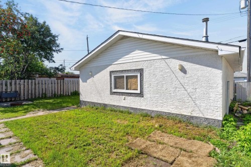 Detached structure with stucco exterior, a single window with dark trim, and a shingled roof - 13214 123 Street Nw, Edmonton, AB 