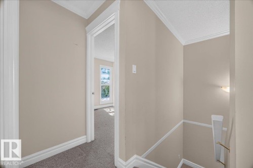 Open doorway leading to a carpeted room with natural light from a window - #47 3812 20 Av Nw, Edmonton, AB 