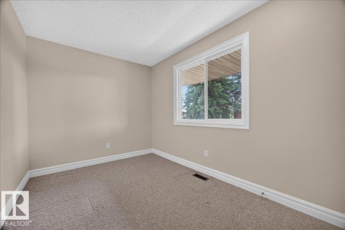Neutral-toned walls complement the carpeted flooring - #47 3812 20 Av Nw, Edmonton, AB 