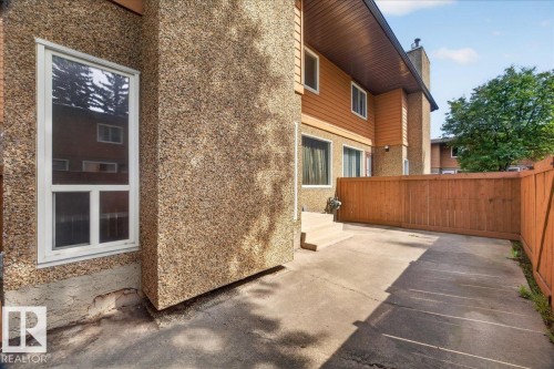 Pebble dash and horizontal siding exterior with white window frames - #47 3812 20 Av Nw, Edmonton, AB 