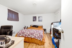 Basement Bedroom - Spacious bedroom featuring wood-finish flooring, ample natural light from multiple windows, and generous floor space accommodating a full bed and additional furnishings - 