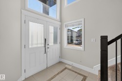 Double entry doors with glass panels and transom window - 