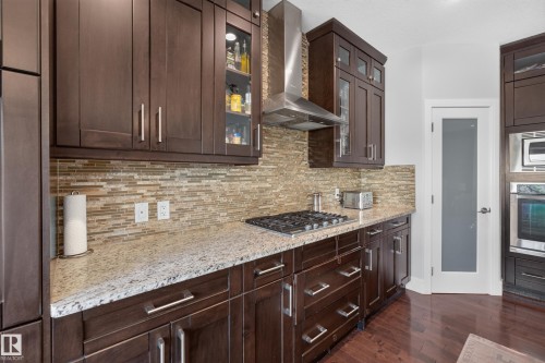 Dark wood-finish cabinetry with silver-tone hardware - 3685 Claxton Place Sw, Edmonton, AB 