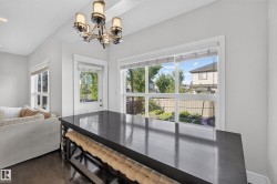 Dark wood-finish flooring, white painted walls, and a multi-pane window - 