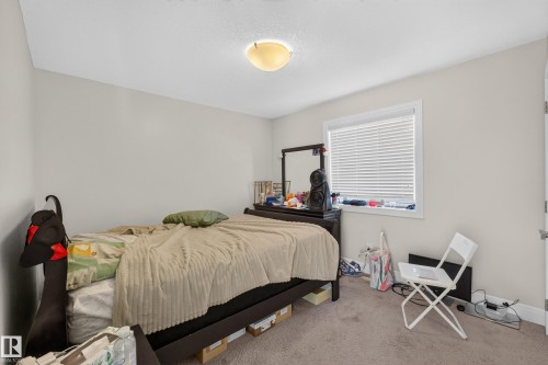 Neutral-toned walls complement the carpeted flooring - 3685 Claxton Place Sw, Edmonton, AB 