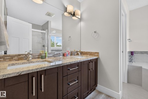 Dual vanity with integrated sinks and a stone countertop - 3685 Claxton Place Sw, Edmonton, AB 