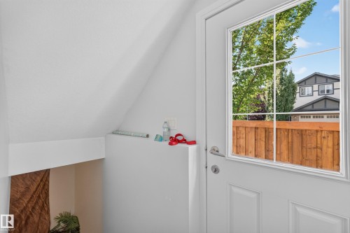 White paneled entry door with grid-patterned window - 3685 Claxton Place Sw, Edmonton, AB 