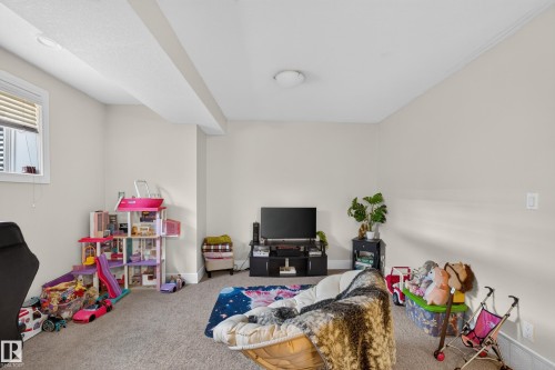 Carpeted room with a ceiling-mounted light fixture, recessed lighting, and a single window with blinds - 3685 Claxton Place Sw, Edmonton, AB 