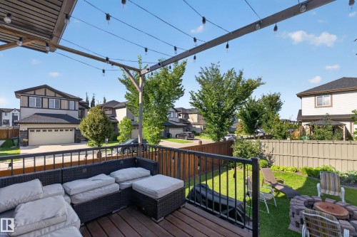 Spacious upper deck with wood-finish flooring and black metal railing - 3685 Claxton Place Sw, Edmonton, AB 