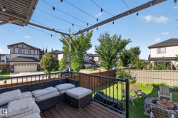 Spacious upper deck with wood-finish flooring and black metal railing - 
