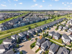 Residential neighborhood with detached homes and multi-family buildings, featuring paved streets and established landscaping - 