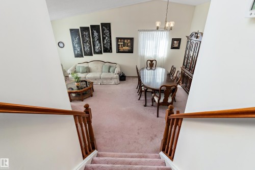 Elegant upper-level landing with hardwood railings and spindles overlooking a spacious great room - 17724 94 Street Nw, Edmonton, AB 