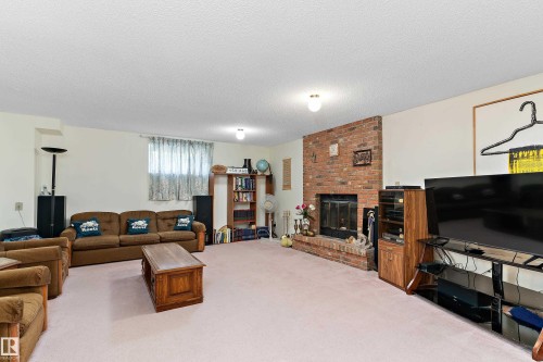 Brick fireplace with a raised hearth - 17724 94 Street Nw, Edmonton, AB 