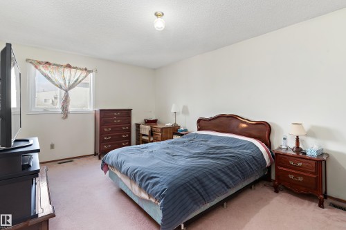 Carpeted flooring, white walls, and a window providing natural light - 17724 94 Street Nw, Edmonton, AB 