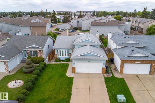 Attached single-family residence with a light blue exterior, gray shingle roof, and an integrated two-car garage - 17724 94 Street Nw, Edmonton, AB 